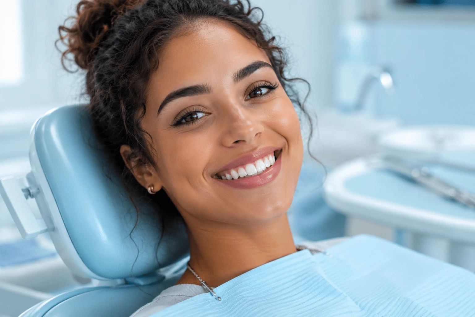 Smiling patient at a modern dental clinic exploring dental insurance plans.