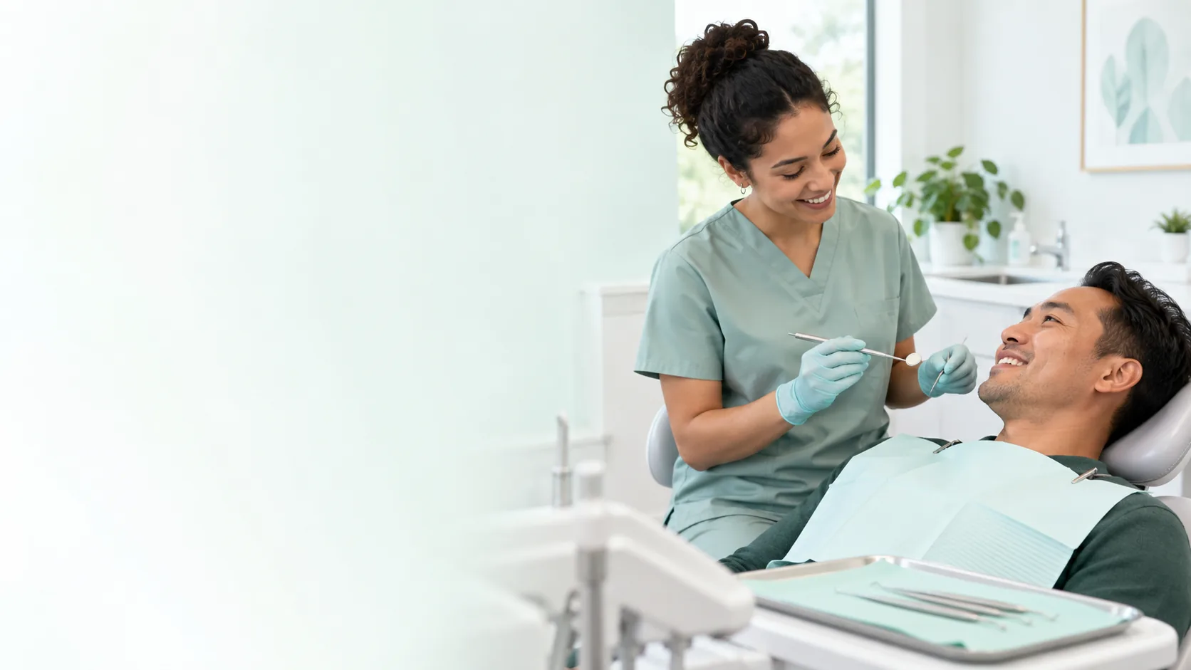 Dental hygienist preparing an adult patient for a routine professional dental cleaning.